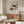 Contemplative modern bird art with geometric and organic shapes in a refined palette of terracotta, cream, and soft neutrals.