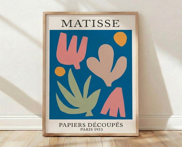 Framed modernist poster featuring abstract organic shapes in sage green, terracotta, golden yellow, and deep blue on cream background, inspired by mid-century cut-paper art.