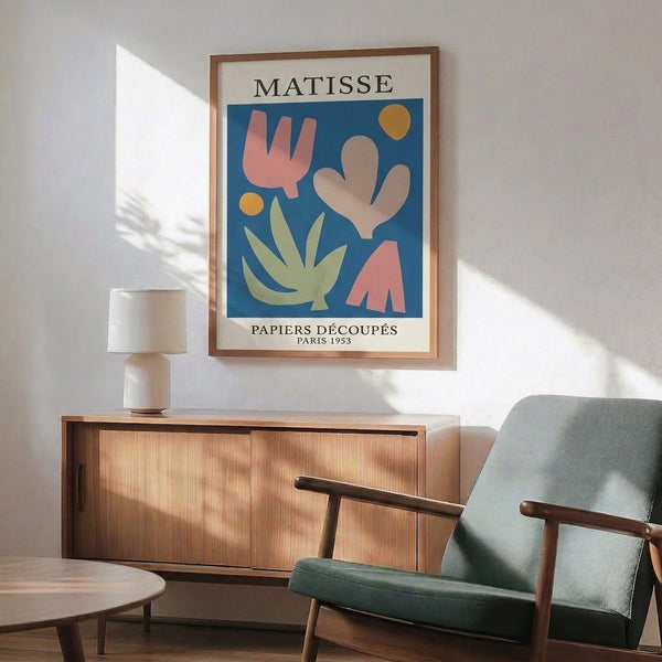 Playful mid-century cut-paper style art featuring cactus-like forms and circles in sage green, terracotta, and deep blue hues.