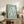 Contemporary art poster featuring abstract figures in motion against a cream and seafoam background with dynamic, rhythmic composition.