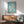 Stylized human figures in mid-dance rendered in seafoam green and cream tones, framed as contemporary minimalist wall decor.