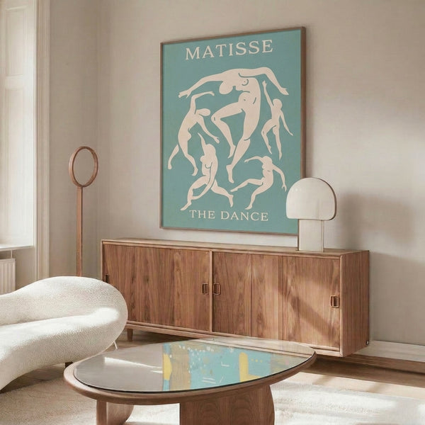 Framed poster of minimalist dancers in soft seafoam palette, celebrating joyful motion through simplified, graceful forms.
