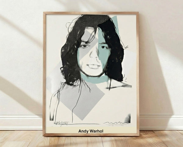 Bold pop art portrait of Mick Jagger in hot pink, mustard yellow, and electric blue with black outlines, framed on a wall.