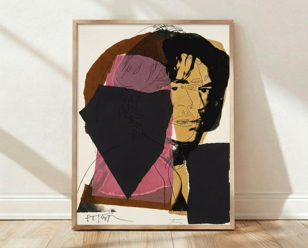 Pop art portrait of Mick Jagger in vibrant contrasting colors with bold graphic shapes, framed on a wall.