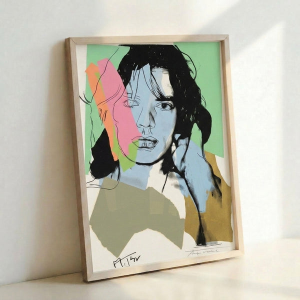 Framed pop art print of Mick Jagger with vivid neon-like color palette and simplified graphic forms, showcasing Warhol's distinctive celebrity portrait approach.
