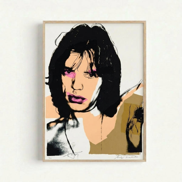 Striking abstract portrait featuring Mick Jagger in electric hues and bold graphic shapes, rendered in iconic pop art style as a framed print on a wall.