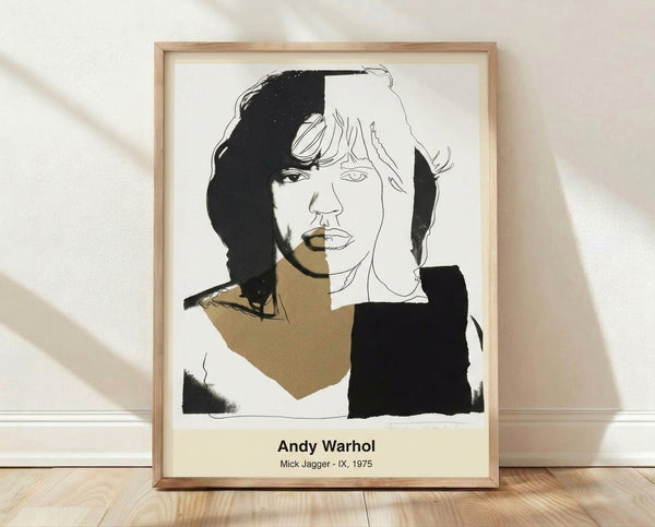 Pop art portrait of Mick Jagger in vibrant cyan, magenta, and yellow with bold black outlines, rendered in Andy Warhol's signature style on a framed poster.