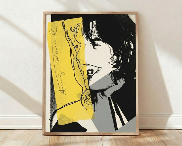 Pop art portrait of Mick Jagger in vibrant contrasting colors with bold graphic style, framed poster on wall.