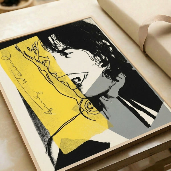 Vibrant pop art interpretation of Mick Jagger's portrait with contrasting hues and contemporary graphic design framed on wall.
