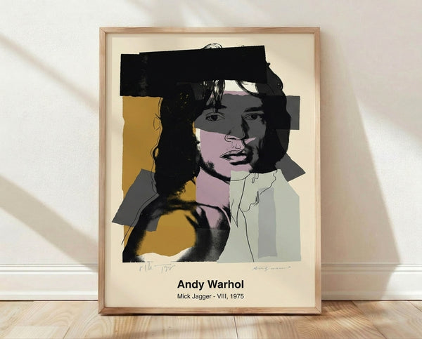 Bold pop art portrait of Mick Jagger in vibrant pink, yellow, and blue tones with black outlines, rendered in the iconic Warhol style on a framed poster.