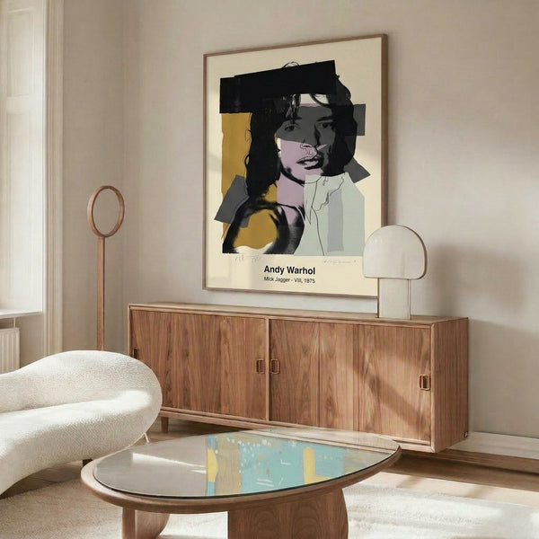 Modern pop art wall art displaying Mick Jagger's portrait in bold, bright colors of pink, yellow, and blue with strong black outlines in a Warhol-influenced approach.