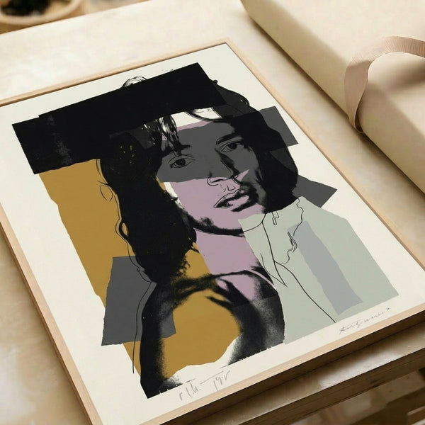 Framed pop art poster of Mick Jagger featuring bold color fields and layered hues in vivid fuchsia, cyan, and lime, evoking Warhol's artistic vision.