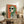 Vintage-inspired dalmatian poster with sunglasses and green scarf, bold retro color palette of orange, cream, slate blue and black on gallery wall.