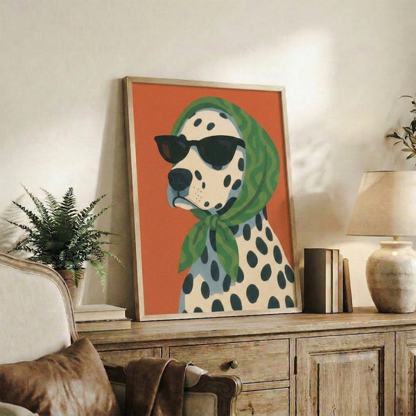 Vintage-inspired dalmatian poster with sunglasses and green scarf, bold retro color palette of orange, cream, slate blue and black on gallery wall.