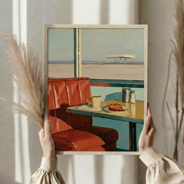 Vintage-style framed poster showing an intimate diner booth scene with warm red and turquoise colors, a coffee cup on the table, and serene desert vista through the window.