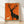 Minimalist silhouette of a stag and fawn standing in grass, rendered in burnt orange and charcoal against cream, framed mid-century modern poster with sage green accents.