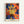 Modern art print featuring a joyful composition of mimosa blossoms rendered in bold, colorful paper cutout forms with warm oranges, yellows, and reds accented by deep blues, displayed as a framed wall poster.