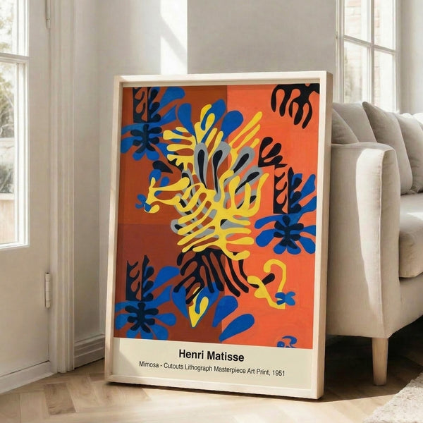 Framed contemporary art print of serene mimosa flowers in warm reds, oranges, and yellows paired with cool blue leaf shapes, created in the bold, colorful cutout style of Henri Matisse.
