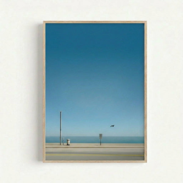 Serene beach scene art print with a contemplative mood, showing a lone bird by seaside structures under a pale sky in muted coastal colors.