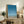 Wabi sabi art print capturing serene beachside beauty with minimal details—a bird, utility structures, and ocean horizon in soft, understated colors.