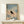 Serene bird silhouette watercolor painting in grey-brown and black tones with soft blue background, displayed as a framed wall print.