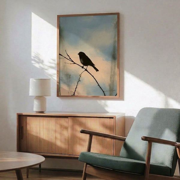 Peaceful minimalist watercolor poster of a bird perched on a branch at dusk, with gentle pale blue and cream tones, hung as framed wall art.