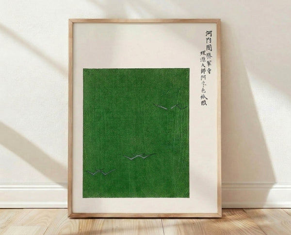 Minimalist Japanese woodblock-inspired framed poster featuring two cranes in a green field with black ink strokes on cream background, serene and contemplative.