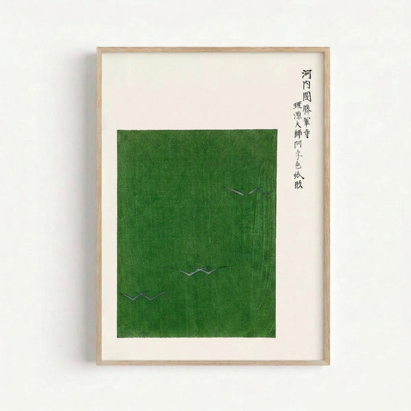 Japandi wall art print showing graceful cranes amid olive and green grass in understated, minimalist style with elegant black calligraphy elements.