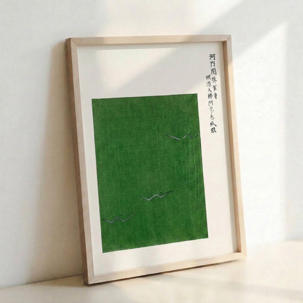 Framed zen landscape art depicting cranes in a green field rendered in traditional Japanese minimalist technique with cream and olive tones.