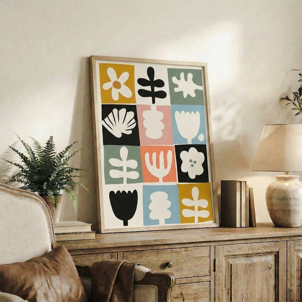 Modern botanical wall art with organized composition of stylized daisies, tulips, and geometric leaf shapes in muted jewel tones.