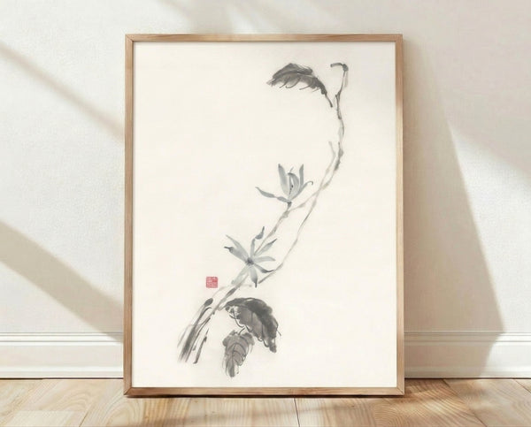Framed minimalist ink wash painting of a delicate lotus branch with flowing stems and blooms in black and gray on cream background, conveying serene contemplative mood.