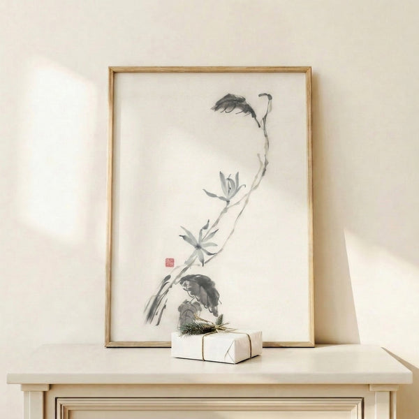 Delicate ink wash artwork depicting a lotus stem and flower in monochromatic tones, capturing contemplative Eastern artistic tradition in modern gallery setting.
