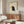 Minimalist raven art print in a modern style featuring bold navy blue and golden yellow elements on a neutral cream canvas, framed on the wall.