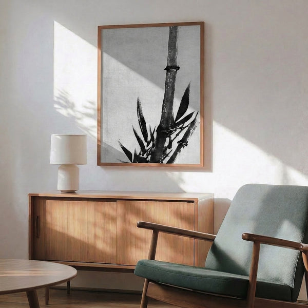 Black ink botanical composition of a graceful bamboo stalk with a lizard among the stems, executed in a reductive, meditative line-art style for modern interiors.