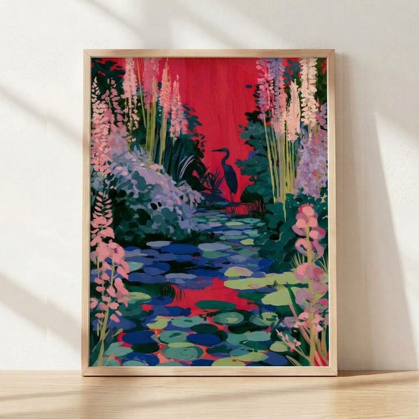 Framed art print of a serene heron standing in a pond surrounded by crimson and coral water lilies, rendered in a whimsical Ghibli-inspired style with deep teal and navy blue tones.