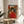 Framed poster showcasing a geisha in cream and red against architectural backdrops, styled as a contemporary take on Showa-era woodblock prints with bold, playful defiance.