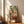 Modern geometric poster with rust and teal color blocks on cream background, creating an abstract composition inspired by overhead perspectives of organized market stalls and book arrangements.