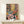 Botanical interior poster displaying an organized collection of potted plants and flowers on shelving with natural light, rendered in modern mid-century style with warm colors.