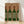 Minimalist Bauhaus poster featuring stylized wine bottles with zebra stripe patterns in burgundy, forest green, and cream tones, framed on a wall.