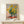 Sunflowers in a rustic vase with creamy whites and gentle sage greens, painted in the Impressionist style with uplifting golden and warm ochre hues throughout.