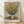 Impressionist oil painting of golden jerusalem artichoke flowers in a vase, rendered in soft yellows, creams, and sage greens with luminous brushwork characteristic of Monet's style.