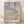 Impressionist painting of poplar trees reflected in water with soft lavender, rose pink, and pale yellow tones, capturing a serene atmospheric landscape framed on a wall.