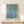 Tranquil impressionist artwork depicting floating lilies and rippling water in soothing shades of blue, green, and pale pink.