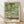 Impressionist framed poster of Monet's Japanese bridge spanning a serene pond with water lilies, soft greens and blues creating a peaceful, contemplative garden scene.