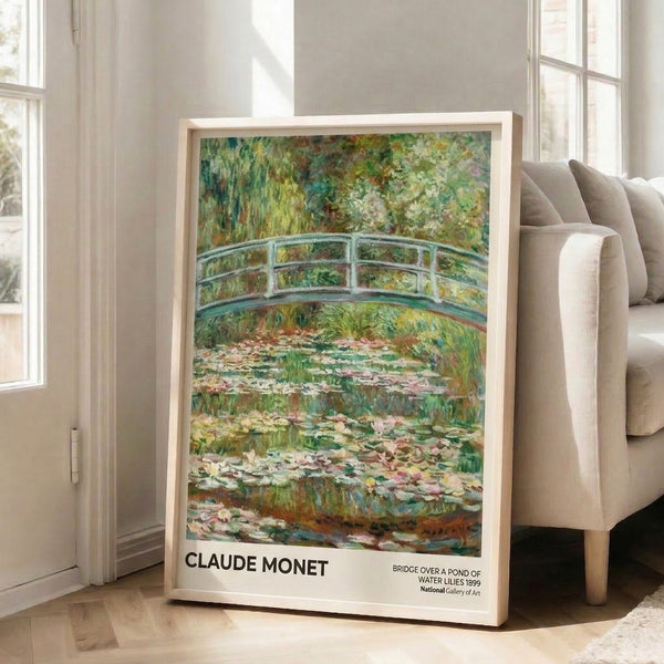 Serene garden wall art print in impressionist style showing an ornamental bridge over a pond with water lilies and drooping willow, painted in muted blues and greens.