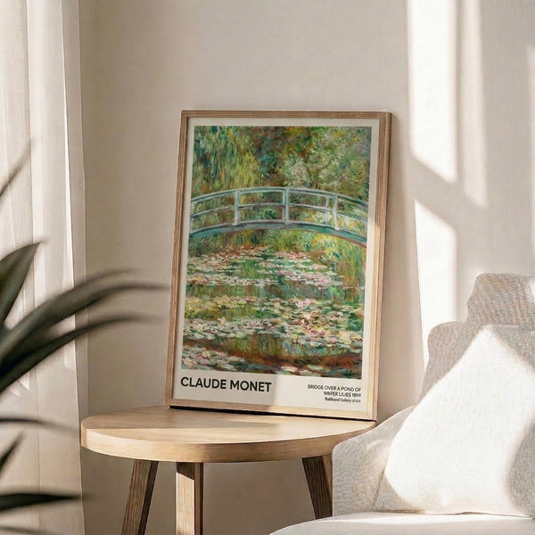 Monet-inspired impressionist poster of an elegant arched footbridge spanning reflective waters with lily pads and a weeping willow, in soft cream, pink, and sage tones.