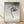 Japanese woodblock print depicting a playful monkey hanging from a branch, rendered in soft grays, blacks, and pale blue with minimalist composition and whimsical charm.