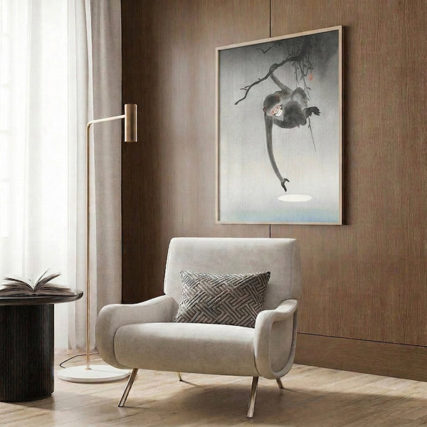 Framed Japandi-style woodblock artwork showcasing a playful monkey hanging mid-swing, rendered with minimalist elegance in gray, white, and soft blue hues.