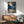Romantic vintage-inspired poster of a moonlit tea ceremony with bamboo stalks, ornamental lantern, and distant mountains rendered in deep blues and warm peachy hues.