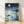 Serene Japanese woodblock print featuring a moonlit pagoda pavilion reflected in still water, rendered in navy blue, cream, and soft green tones with minimalist aesthetic.